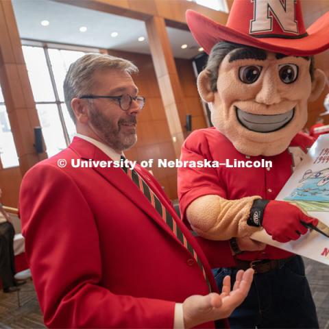 Herbie Husker is with Chancellor Ronnie Green looking at a display of the $1 cost to attend UNL and points to a post-it note asking if we could go back to that tuition. Everyone was invited to enjoy a cupcake and join in the festivities with their Husker friends at the Wick Alumni Center, Friday February 15th. The Nebraska Charter was available to view, along with other historical items. Copies of Dear Old Nebraska U could be purchased and signed. Charter Day at the Wick Alumni. February 15th, 2019. Photo by Gregory Nathan / University Communication.